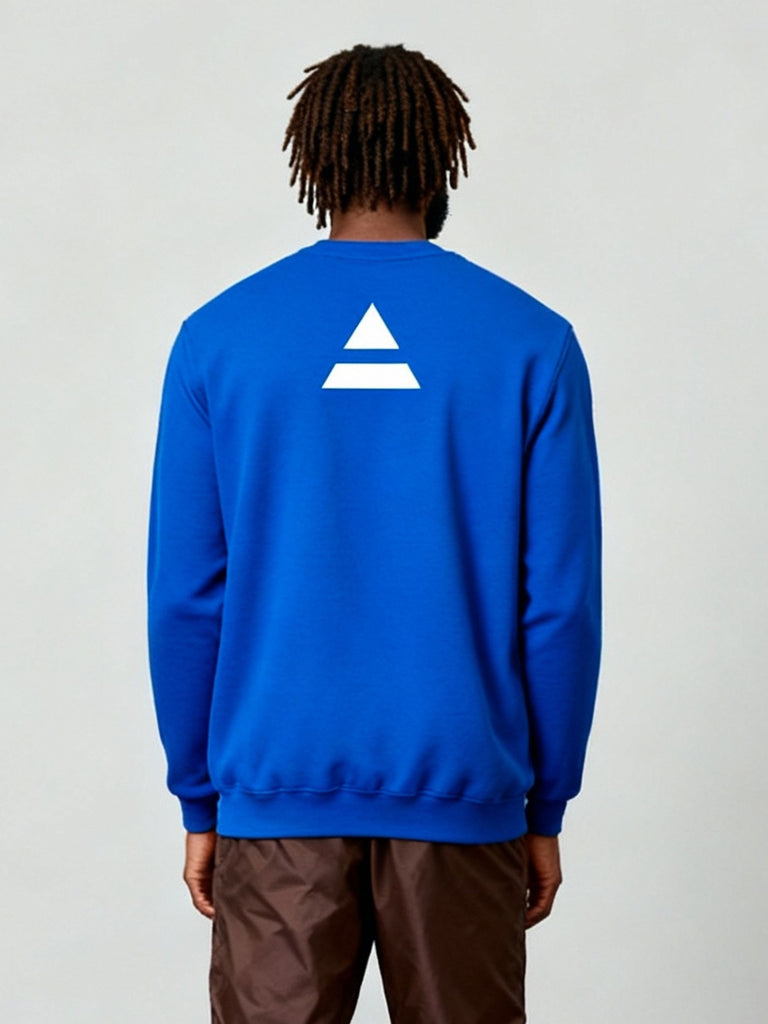 Three-quarter back view of model wearing the blue sweatshirt with the minimalist white triad logo printed at the upper back.