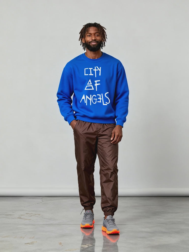 Video of male model wearing the royal blue City of Angels sweatshirt, standing against a neutral backdrop. The sweatshirt features the bold white “City of Angels” text on front.